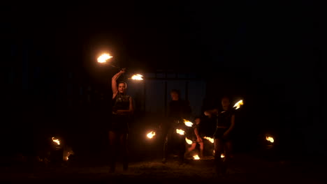 A-group-of-professional-artists-with-fire-show-the-show-juggling-and-dancing-with-fire-in-slow-motion
